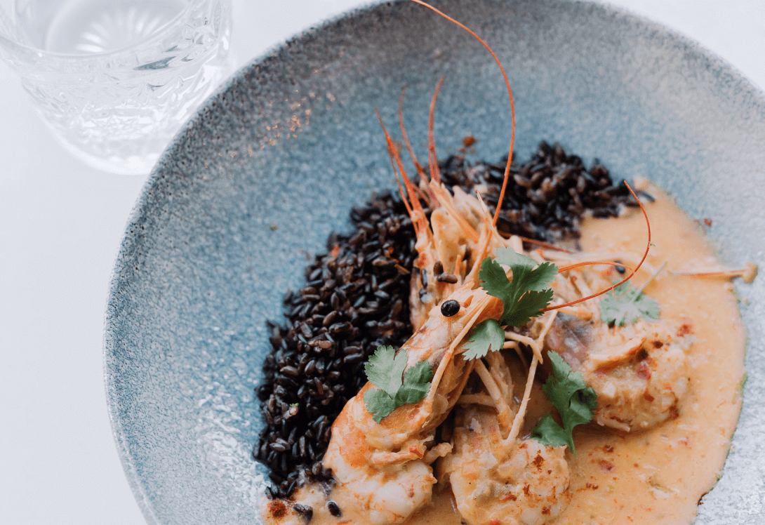 The Intersection of African Art and Culinary Arts: A Feast for the Senses | © Pierre Thiam - Prawns in coconut & lime over millet couscous thiéré