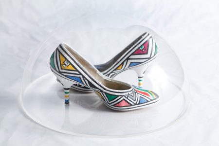 Then I Knew I Was Good at Painting: Esther Mahlangu, A Retrospective - (Suid Afrika Vorentoe (South Africa Ahead) 2003 | Acrylic on ballroom shoes | 34 x 38 x 20cm (perspex dome)